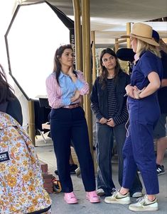 several women standing around talking to each other