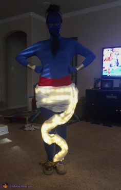 a woman in blue and white costume standing with her hands on her hips as if she is dancing