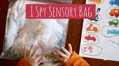 a young boy holding his hands in front of a plastic bag with the words i spy sensory bag on it