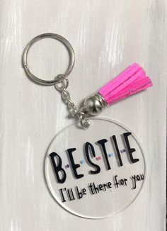 a keychain with the words besite and a tassel on it