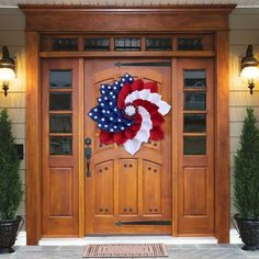 an american flag wreath on the front door of a house