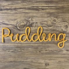 the word prudding spelled with rope on a wooden background