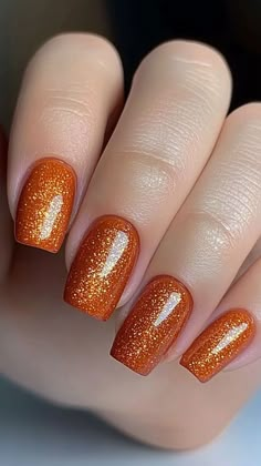 Shine bright this fall with Burnt Orange Glitter nails that add a touch of sparkle to your autumn style! Perfect for making a bold statement, these nails will keep you glowing all season long. Click the pin and follow us for more fall nail ideas! #FallNails #OrangeNails #GlitterNails #AutumnBeauty #NailArtInspo Orange Glitter Gel Nails, Oct Nail Designs, Brown And Orange Fall Nails, Hunter Orange Nails, Burnt Orange Glitter Nails, Fall Burnt Orange Nails, Autumn Nails Glitter, Fall Finger Nails, Autumn Nails Squoval