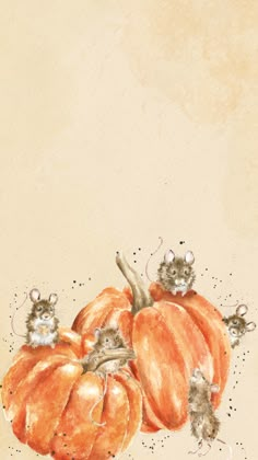 two pumpkins with mice on them sitting next to each other in front of a beige background