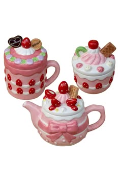 three ceramic teapots with designs on them and one has an ice cream sundae