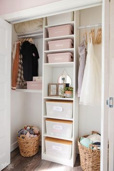 an organized closet with baskets and clothes