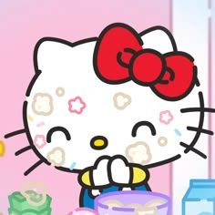 the hello kitty character is holding a bowl of cash