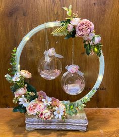 a glass sculpture with flowers and lights around it