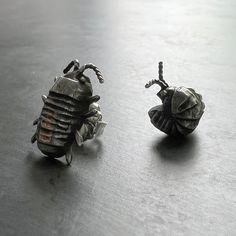 These mismatched sterling silver isopod stud earrings earrings are the perfect accessory for gardening, going to a garden party, and everything in between! Hand cast in solid sterling silver (or bronze, if you choose!) and handcrafted with love, these studs are a completely original, hand carved design, featuring one curled isopod and one crawling isopod. Also available in bronze, with sterling silver post and post clutch in the back.What would you have called one of these critters when you were Bug Earrings, Carved Designs, Hand Cast, Handmade Sterling Silver, Garden Party, A Garden, Biodegradable Products, My Jewellery, Hand Carved