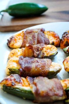 bacon wrapped jalapenos on a white plate