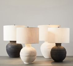 three lamps sitting on top of a table next to each other