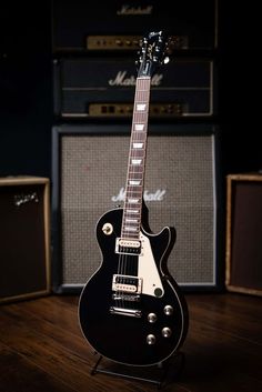 an electric guitar sitting on top of a wooden floor