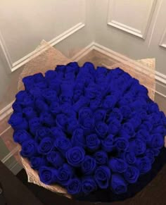 a bouquet of blue roses sitting on top of a table