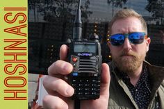 a man holding up a cell phone in his hand