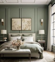 a bedroom with green walls and white bedding