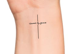 a woman's wrist with the words saved by grace written on her left arm