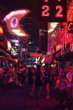 many people are walking down the street at night with neon signs on buildings in the background