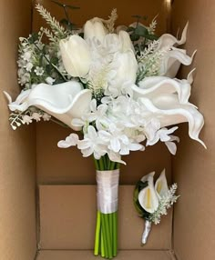 a bouquet of white flowers in a cardboard box