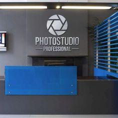 the front desk of a photography studio with blue and grey accents on it's walls