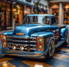 an old blue pickup truck parked on a checkered floor in front of a store