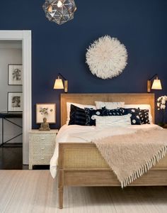 a bedroom with blue walls and white furniture