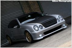 a silver car parked in front of a garage door