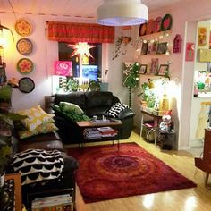 a living room filled with lots of furniture and decor on top of a hard wood floor