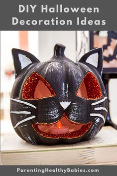 a black cat pumpkin sitting on top of a stack of books