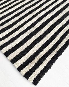 a black and white striped rug is laying on the floor