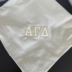 This precious sweatshirt blanket is the perfect way to bring bright & fun to your everyday routine. This blanket will be embroidered with the colors of your choice for your greek letters. Outlined in gold or silver thread, on a blanket color of your choice, this really is a totally customizable piece! Sample blanket is Sand with white thread, gold outline • 50% cotton / 50% polyester• Air jet yarn for softer feel and reduced pilling• DryBlend® technology delivers moisture-wicking properties• Hem Faux Chenille, Sorority Sweatshirts, Sorority Merch, Sweatshirt Blanket, Everyday Routine, Greek Letters, A Blanket, Air Jet, Color Names