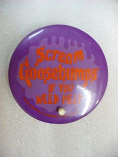 a purple frisbee with orange writing that says scream goosebumps if you need me