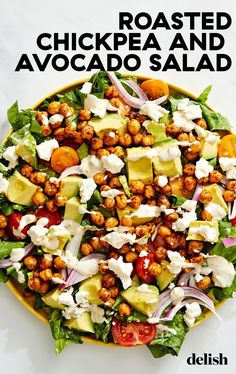 a salad with chickpea and avocado is shown in a yellow bowl