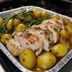 a pan filled with chicken, potatoes and green beans