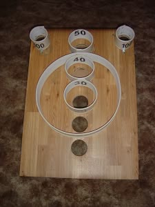 a wooden table topped with lots of white cups and numbers on top of each other