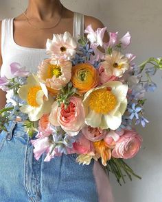 a woman holding a large bouquet of flowers