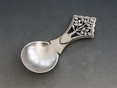 a spoon with a tree design on it