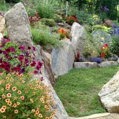 a garden with rocks and flowers in it