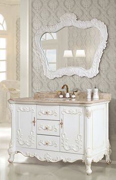 a white bathroom vanity with a large mirror above it