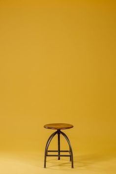 a small wooden table sitting on top of a yellow floor