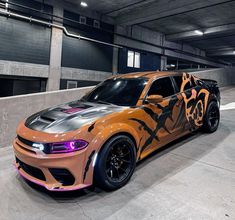 an orange and black camo car parked in a parking garage