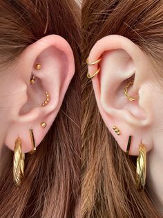 two pairs of ear piercings are shown in the shape of an ear with gold spikes