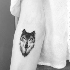 a black and white photo of a wolf on the arm