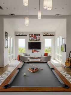 a pool table in the middle of a living room