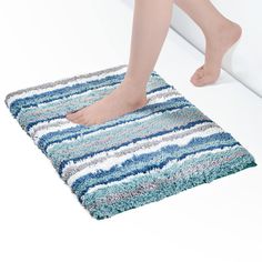 a person standing on top of a bathroom rug