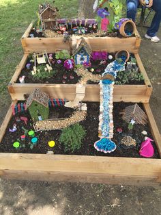 a garden filled with lots of different types of plants and decorations on top of dirt