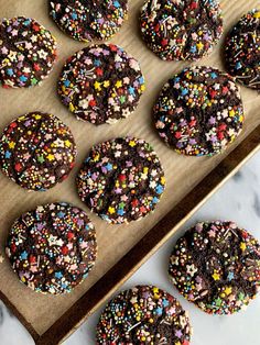 chocolate cookies with sprinkles on a baking sheet