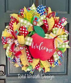 a colorful wreath with the words welcome on it and a red apple in the center