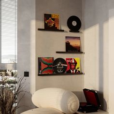 a white couch sitting in front of a wall mounted record player