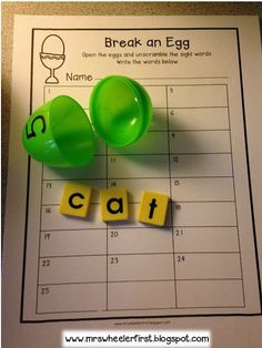 the word cat spelled out with letters next to an egg on top of a calendar