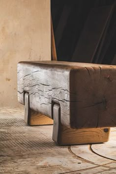 a wooden bench sitting on top of a floor next to a door and window sill